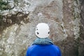 Young man wearing in climbing equipment with rope standing in front of a stone rock Royalty Free Stock Photo