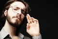 Young man wearing eyeglasses over black background. Lifestyle concept. Royalty Free Stock Photo