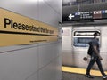 Young Man Wearing Face Mask in NYC Subway Platform with Social Distance Sign MTA New York