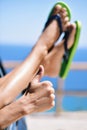 Young man wearing flip-flops relaxing in a car near the ocean Royalty Free Stock Photo