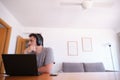 Young man wearing headphones distracted watching series, videos, instead his online classes Royalty Free Stock Photo