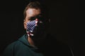 Young man wearing mask for protection from corona virus covid-19 with us flag Royalty Free Stock Photo