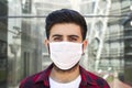 Young man wearing medical face mask, portrait. Man wearing surgical mask for corona virus