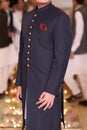 Young man wearing a Pakistani traditional dress red pocket square