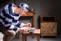 Young man wearing prison uniform eating from aluminum dishes in Royalty Free Stock Photo