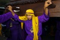 Young man wearing a purple and yellow robe, carrying a float anda during the Easter celebrations, in the Holy Week, in Antigua,