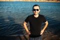 Young handsome man wearing spectacles and having fun on sea beach Royalty Free Stock Photo