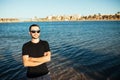 Young handsome man wearing spectacles and having fun on sea beach Royalty Free Stock Photo