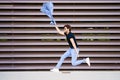 Young man wearing a suit jumping outdoors Royalty Free Stock Photo