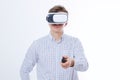 Young man wearing virtual reality goggles isolated on white background. Digital VR glasses for 360 game. Template and blank shirt. Royalty Free Stock Photo