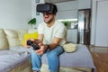 Man wearing virtual reality goggles in the living room and play video game Royalty Free Stock Photo