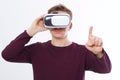 Young Man wearing virtual reality goggles and toch space by finger isolated on white background. VR concept and copy space. Royalty Free Stock Photo