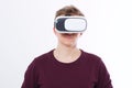 Young Man wearing virtual reality goggles isolated on white background. VR concept and copy space. Royalty Free Stock Photo