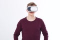 Young Man wearing virtual reality goggles isolated on white background. VR concept and copy space. Royalty Free Stock Photo