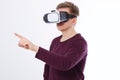 Young Man wearing virtual reality goggles and toch space by finger isolated on white background. VR concept and copy space.