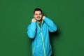 Young man wearing warm clothes on color background. Ready for vacation Royalty Free Stock Photo