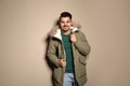 Young man wearing warm clothes on color background Royalty Free Stock Photo