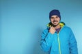 Young man wearing warm clothes on color background Royalty Free Stock Photo