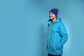 Young man wearing warm clothes on color background, space for text. Ready for winter Royalty Free Stock Photo