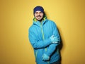 Young man wearing warm clothes on color background, space for text. Ready for winter Royalty Free Stock Photo