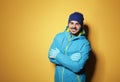 Young man wearing warm clothes on color background, space for text. Royalty Free Stock Photo