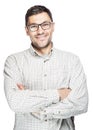 Young man wearing white checkered shirt and glasses standing with crossed arms and smiling. Royalty Free Stock Photo