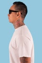 Young hipster men wearing t shirt and sunglasses in left side view Royalty Free Stock Photo