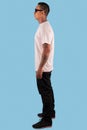 Young man wearing white t shirt isolated on white background. Young hipster man wearing t shirt and sunglasses in left side view Royalty Free Stock Photo