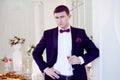 Young man at the wedding, the groom with a glass of champagne Royalty Free Stock Photo