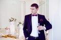 Young man at the wedding, the groom with a glass of champagne Royalty Free Stock Photo