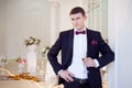 Young man at the wedding, the groom with a glass of champagne Royalty Free Stock Photo