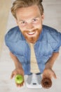 young man on weighing scale holding apple and donut Royalty Free Stock Photo