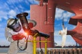 A young man welder in brow uniform welding process Royalty Free Stock Photo