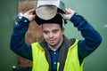 Young man welder with Down syndrome working in industrial factory, social integration concept. Royalty Free Stock Photo