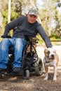 Young man in a wheelchair with his faithful dog. Royalty Free Stock Photo