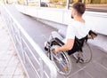 Young man in wheelchair on ramp outdoors Royalty Free Stock Photo