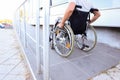 Young man in wheelchair on ramp outdoors Royalty Free Stock Photo