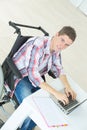 Young man in wheelchair using computer