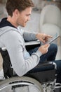 young man in wheelchair using tablet Royalty Free Stock Photo