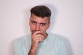 Young man on white background looking with questioning face. Concept different expressions Royalty Free Stock Photo