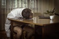 Young man in a white shirt with a tie and underwear was working at a computer at home tired and laid his head on the table. Royalty Free Stock Photo