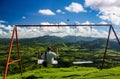 A young man in white T-shirt swinging on a swing Royalty Free Stock Photo