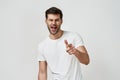 Young man in white t-shirt winking Royalty Free Stock Photo