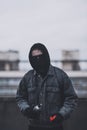 Young man who hides his face preparing to make graffiti. Urban view Royalty Free Stock Photo