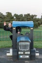 A young man who refuses to grow up enjoying children`s play equipment reliving his youth