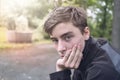 Young man who is resting his head on his hand