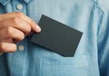 Young man who takes out black blank business card from the pocket of his shirt Royalty Free Stock Photo