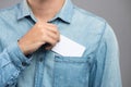 Young man who takes out blank business card from the pocket of h Royalty Free Stock Photo