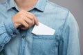 Young man who takes out blank business card from the pocket of h Royalty Free Stock Photo