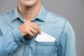 Young man who takes out blank business card from the pocket of h Royalty Free Stock Photo